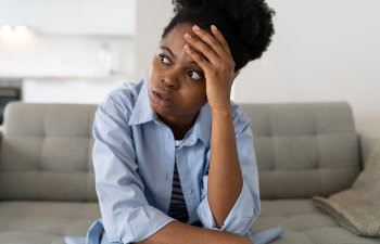 concerned woman sitting on the sofa